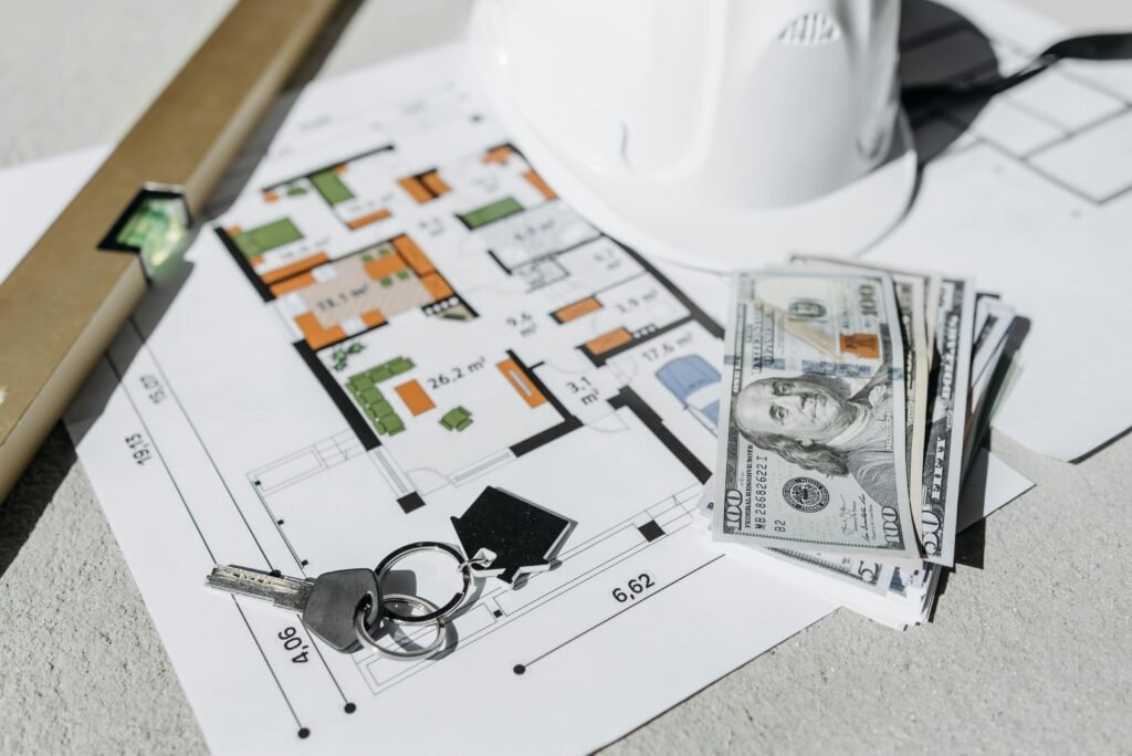 House Map Planning in Seohara: Complete Guide for Beginners by UA Map Studio Seohara |
| Floor plan with cash, keys, and hard hat symbolizing real estate investment and property planning.