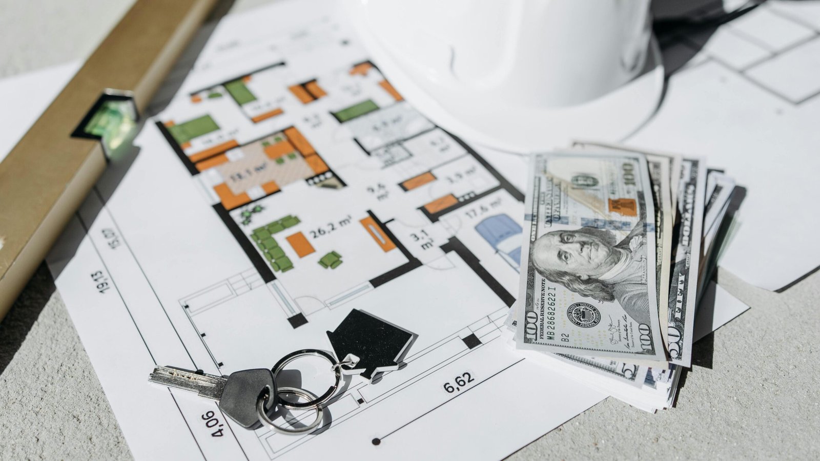 घर का नक्शा बनवाते समय क्या ध्यान रखें: UA Map Studio Seohara | Dist- Bijnor | Floor plan with cash, keys, and hard hat symbolizing real estate investment and property planning.