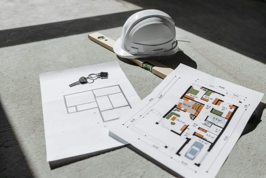 Property Measurements Guide: How to Measure a Plot Accurately | UA Map Studio Seohara, Dist- Bijnor | Architectural floor plans with helmet and keys on sunlit floor, perfect for real estate or construction themes.