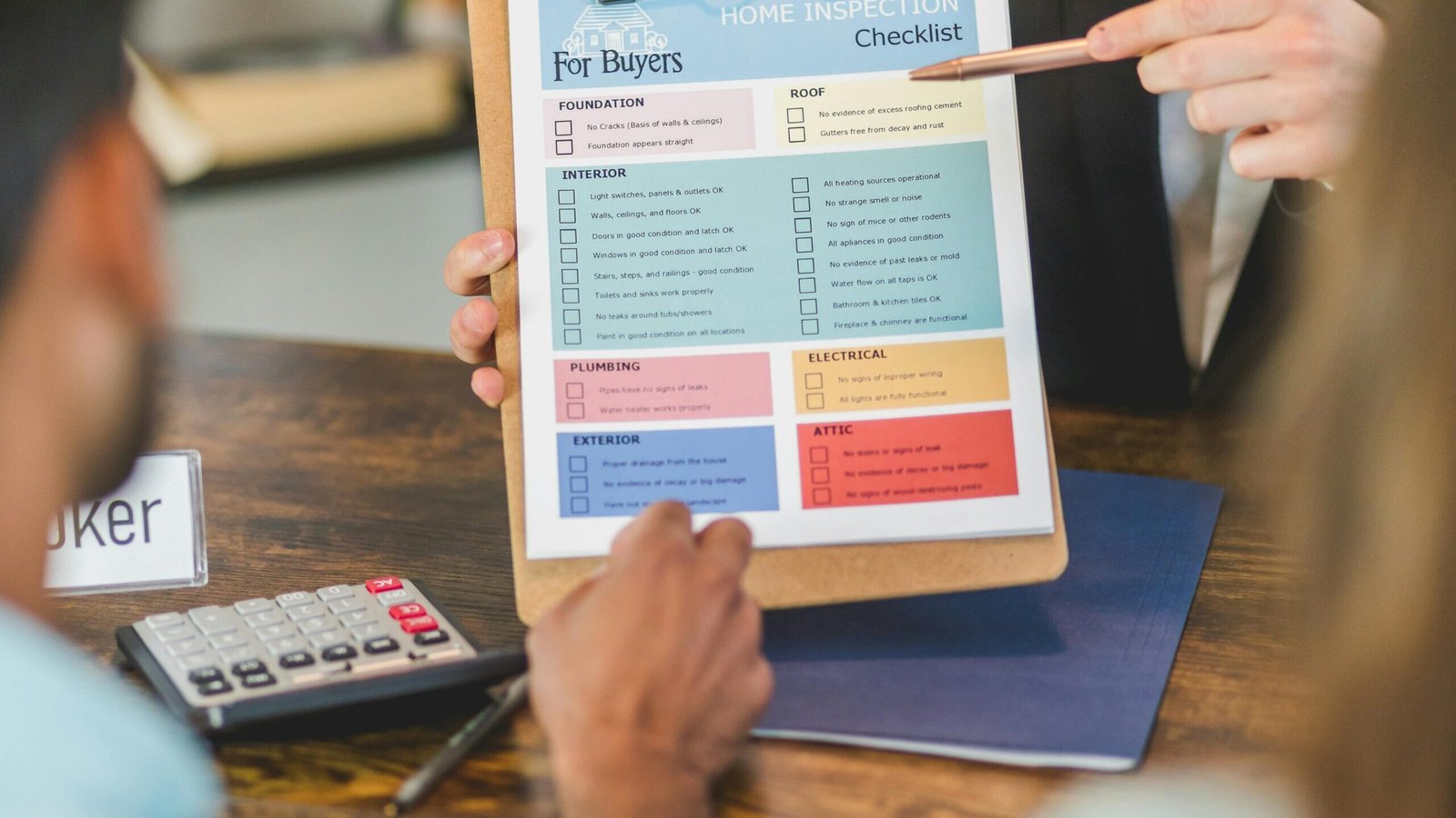 The Property Buying Process in seohara district bijnor by UA Map Studio Seohara | Realtor explaining home inspection details to clients at office with checklist and calculator.
